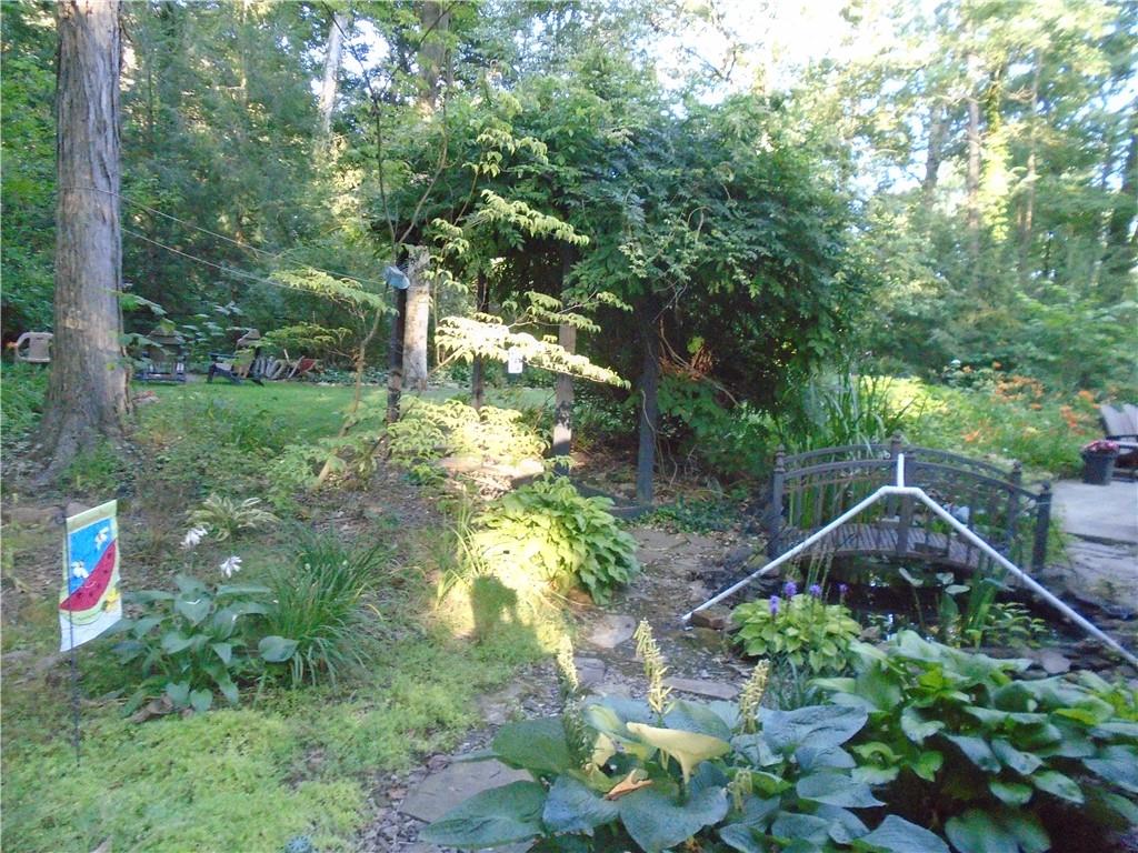 124 Heath Drive Baden, PA 15005 - Photo 32 of 38 a backyard of a house with lots of green space and lake view