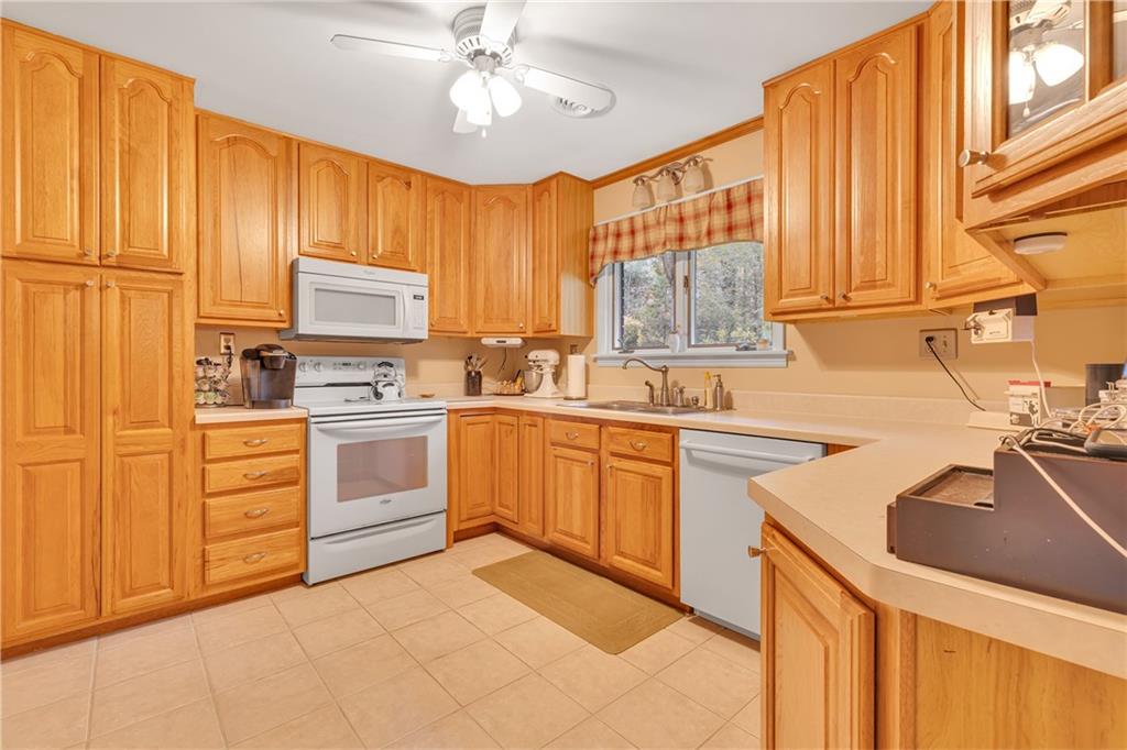 124 Heath Drive Baden, PA 15005 - Photo 8 of 38 a kitchen with kitchen island granite countertop a sink appliances cabinets and furniture