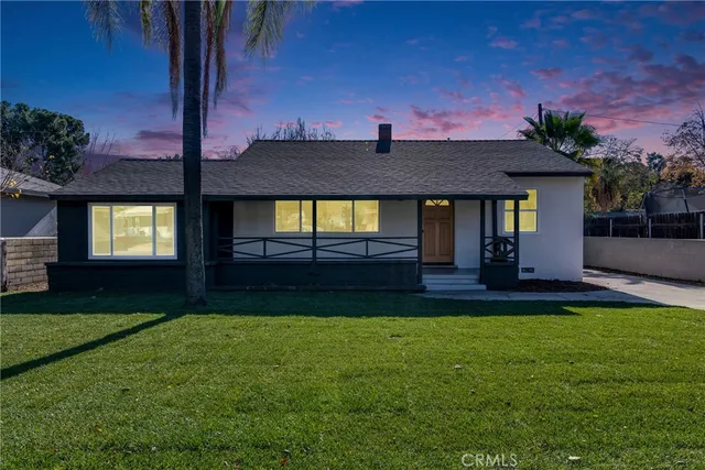 a front view of house with yard and outdoor seating