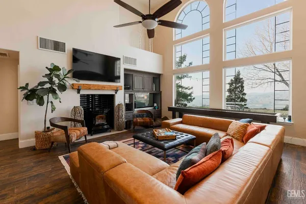 a kitchen with stainless steel appliances granite countertop sink stove and white cabinets with wooden floor