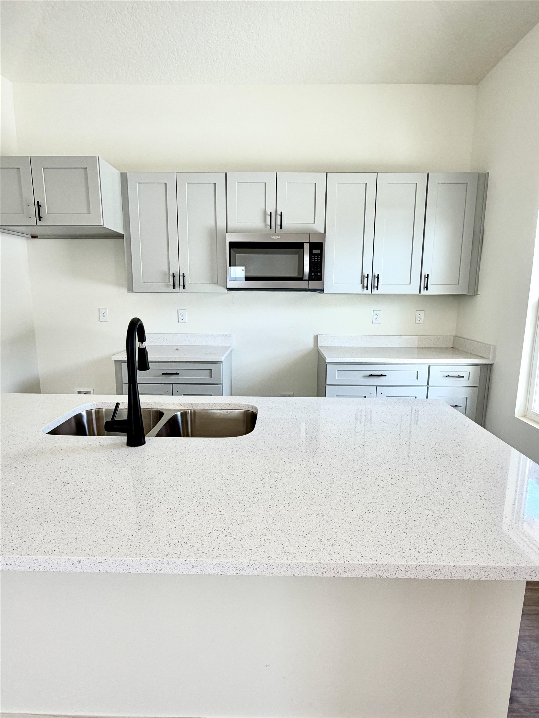 252 Jackson Boulevard St. Augustine, FL 32095 - Photo 3 of 5 a kitchen with stainless steel appliances a sink a stove and white cabinets