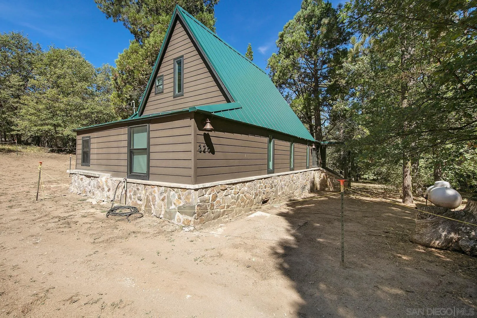 326 Laguna Tract Road Pine Valley, CA 91962 - Photo 27 of 29 a backyard of a house with large trees and covered with snow