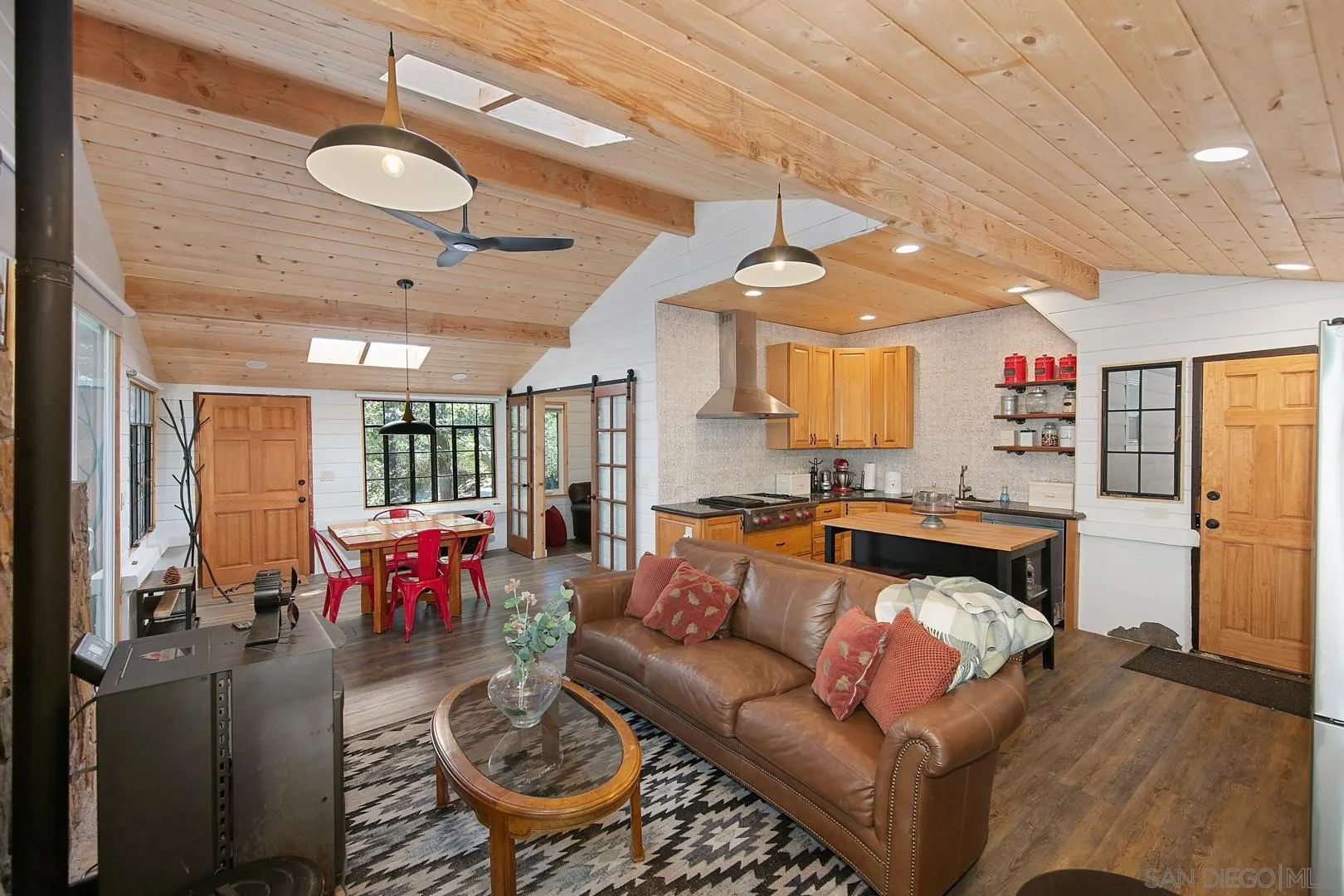 326 Laguna Tract Road Pine Valley, CA 91962 - Photo 4 of 29 a living room with furniture a chandelier and a dining table