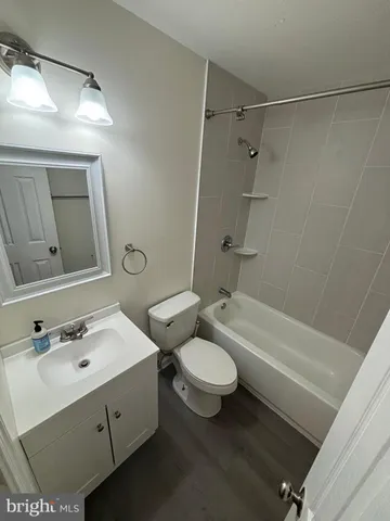 a bathroom with a double vanity sink toilet mirror and shower