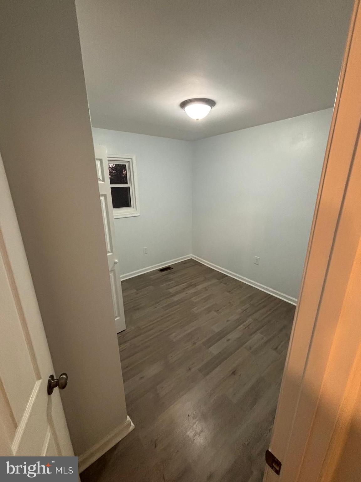 926 Anvil Road Fredericksburg, VA 22405 - Photo 9 of 11 an empty room with wooden floor and windows