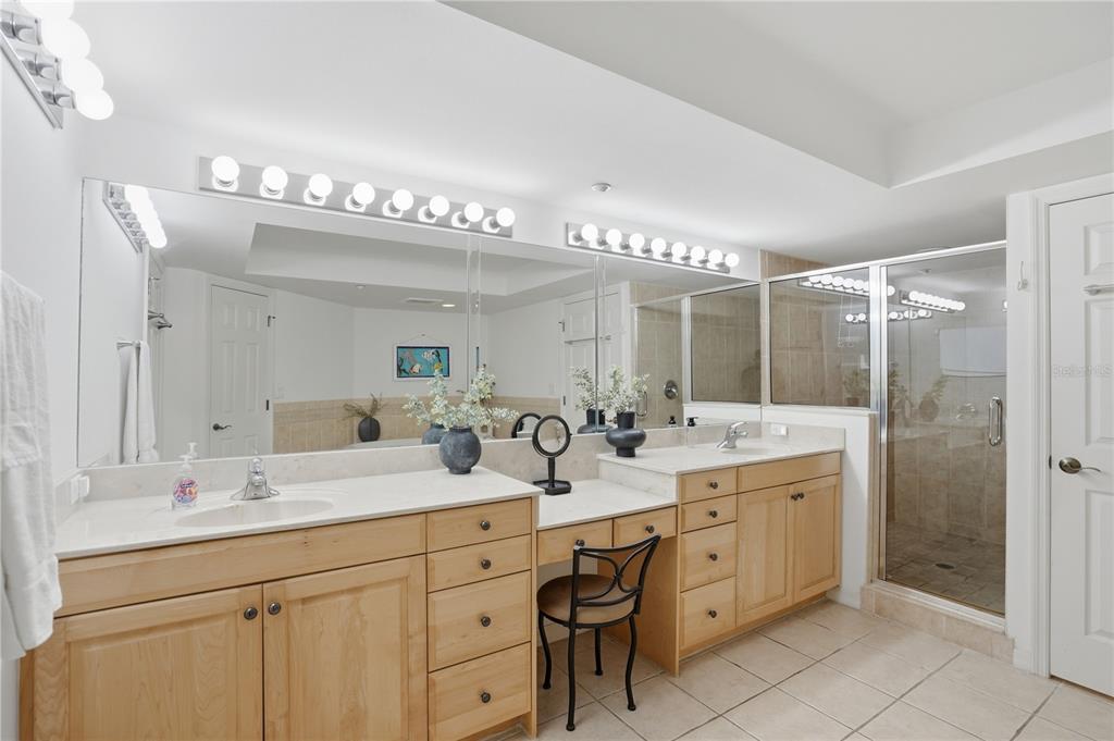 16326 Gulf Boulevard, Unit 307 Redington Beach, FL 33708 - Photo 16 of 43 a bathroom with a double vanity sink mirror and double