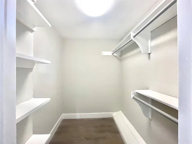 a bathroom with a white floor and toilet