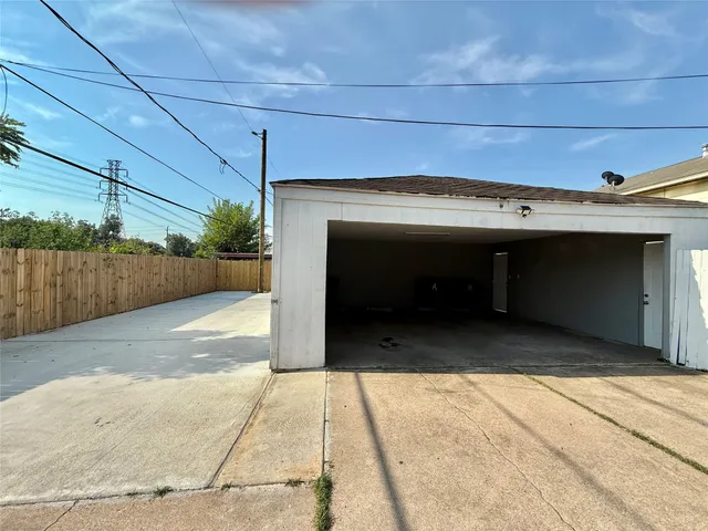 a view of a room with a wooden floor and a fireplace