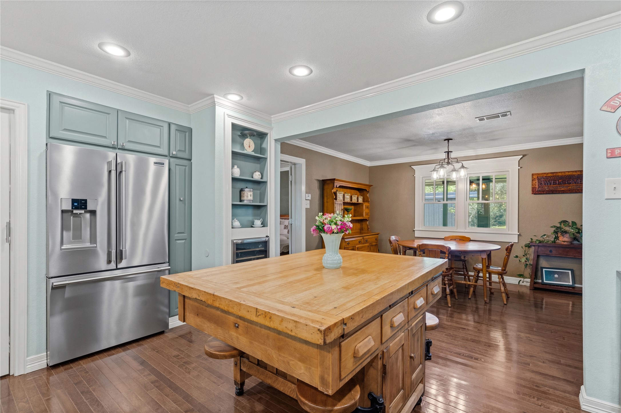 17821 Brown Road Conroe, TX 77306 - Photo 19 of 50 a kitchen with stainless steel appliances a dining table chairs refrigerator and wooden floor