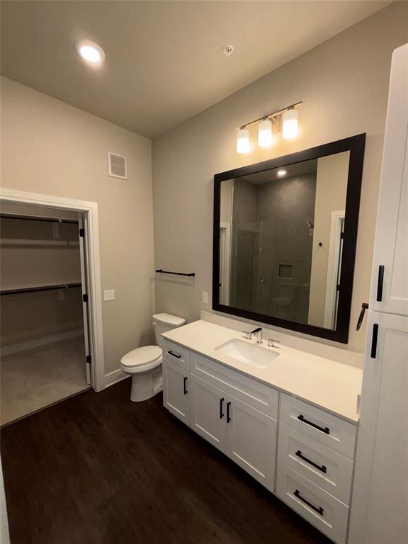 111 Town Place, Unit 2290 Fairview, TX 75069 - Photo 10 of 30 a bathroom with a toilet sink double vanity and mirror