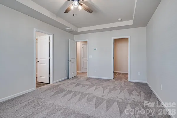 an empty room with fan and entrance