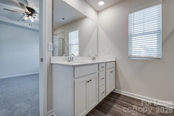 a bathroom with a sink a mirror and a vanity