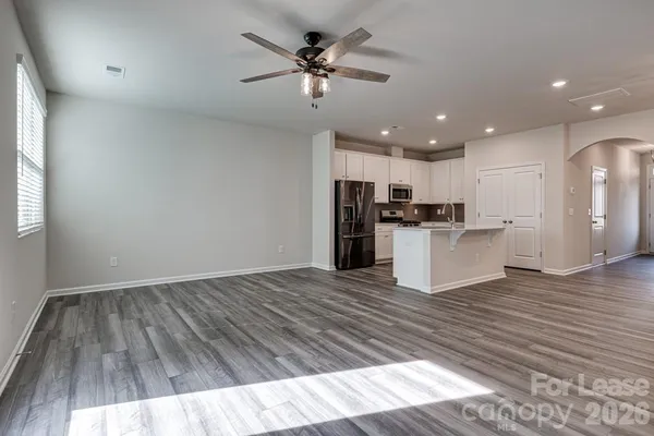 a view of kitchen with cabinets appliances and wooden floor