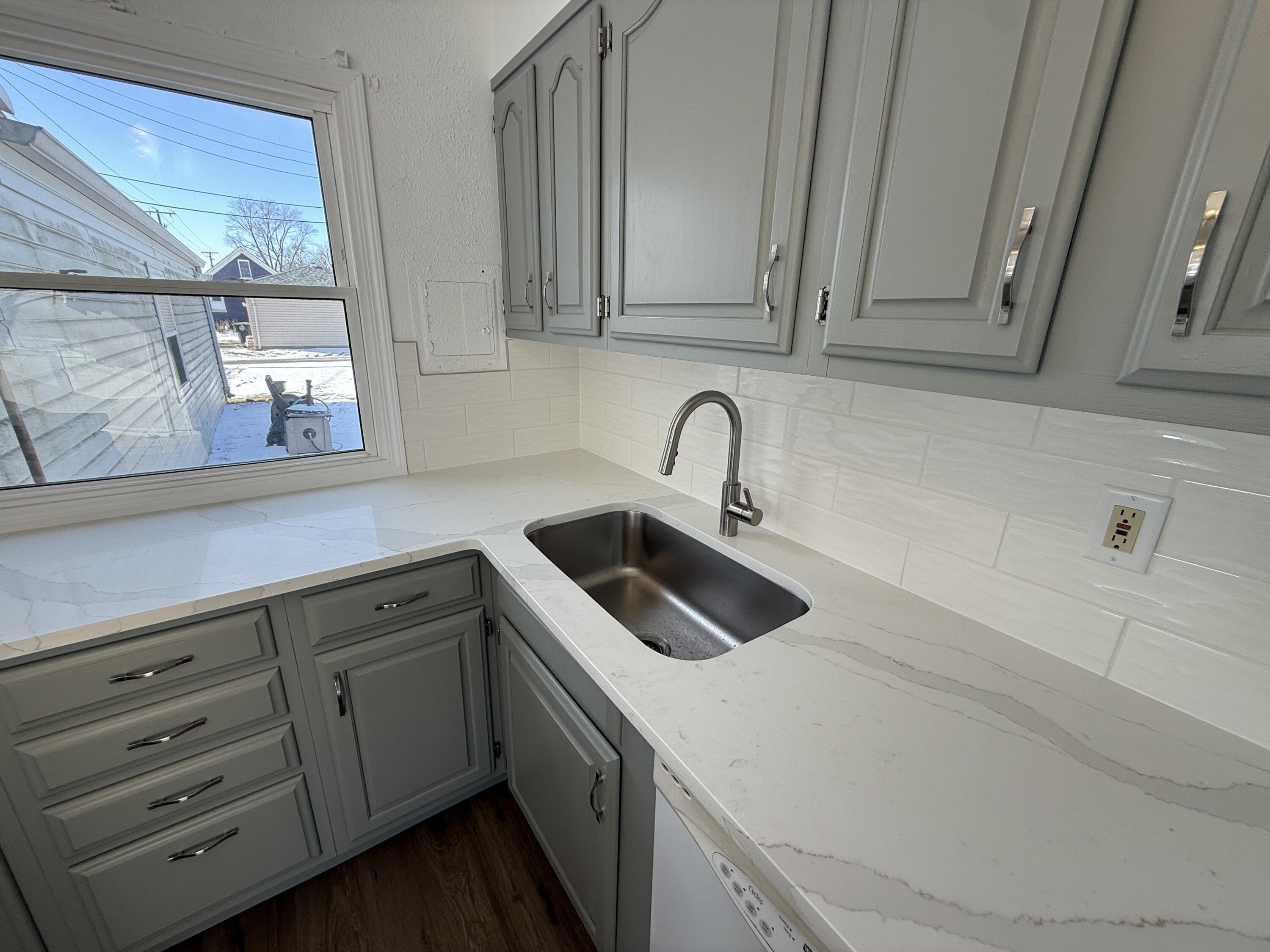 400 North Virginia Street Hobart, IN 46342 - Photo 2 of 13 a kitchen with white cabinets and sink