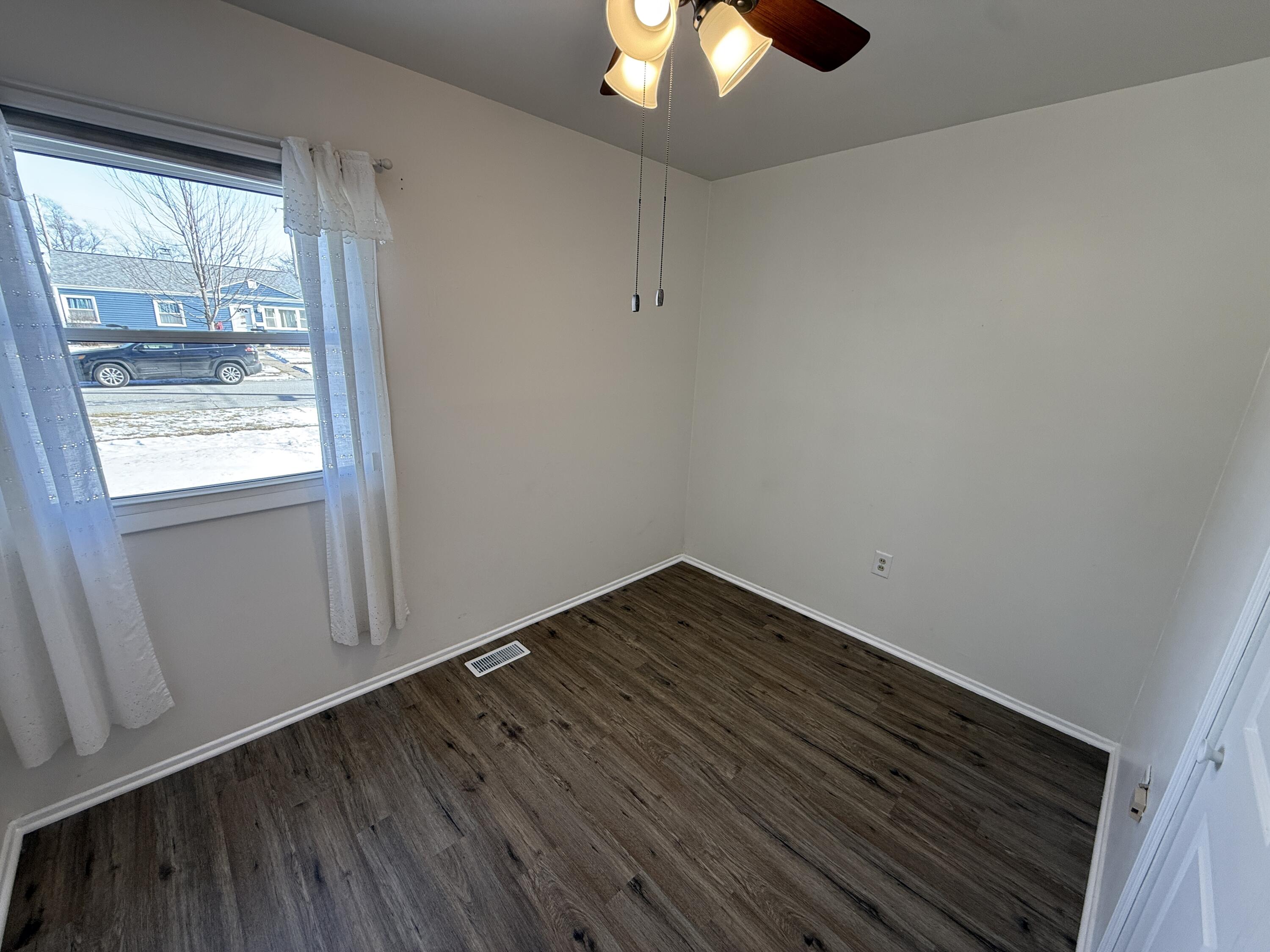 400 North Virginia Street Hobart, IN 46342 - Photo 6 of 13 wooden floor in an empty room with a window