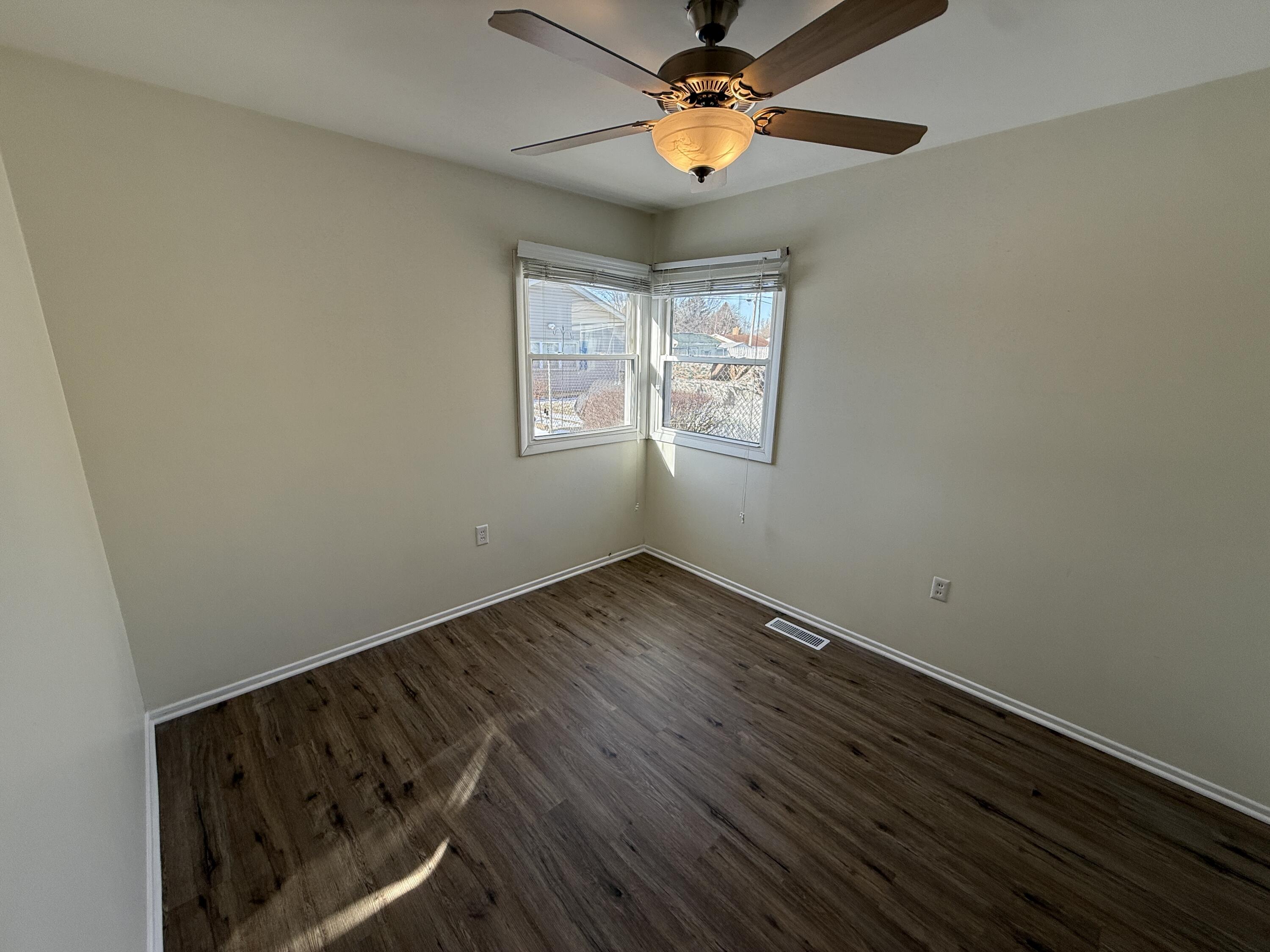 400 North Virginia Street Hobart, IN 46342 - Photo 8 of 13 an empty room with wooden floor and windows