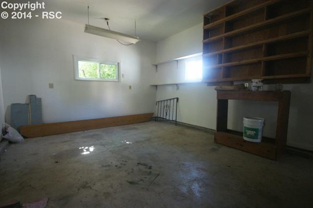 1133 Wooten Road Colorado Springs, CO 80915 - Photo 9 of 21 Workshop, built in back of existing garage, Could be opened up for a 2 car tandem garage.