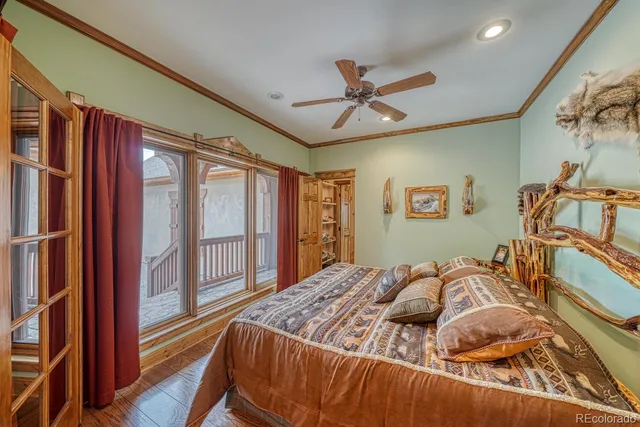 a bedroom with a bed and a large window with the outer view