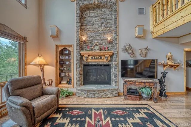 a living room with furniture a flat screen tv and a floor to ceiling window