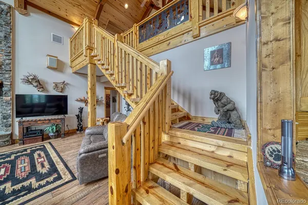 a view of entryway livingroom and hall with wooden floor