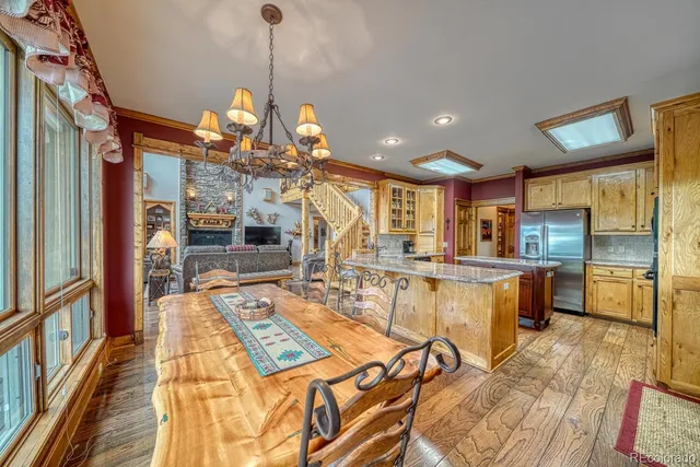 a kitchen with stainless steel appliances granite countertop wooden floors and sink