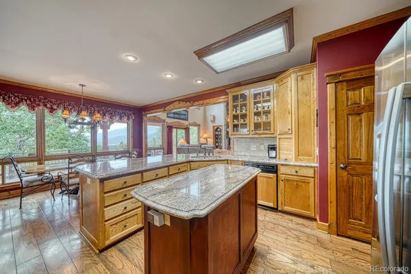 a kitchen with granite countertop stainless steel appliances stove and cabinets