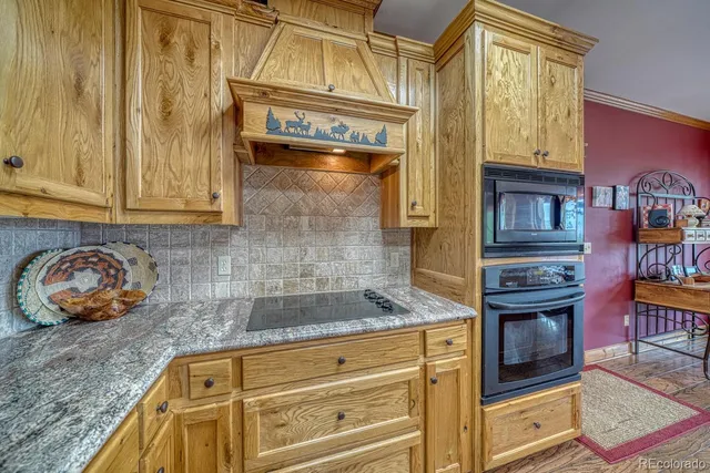 a bathroom with a granite countertop shower a mirror and a sink