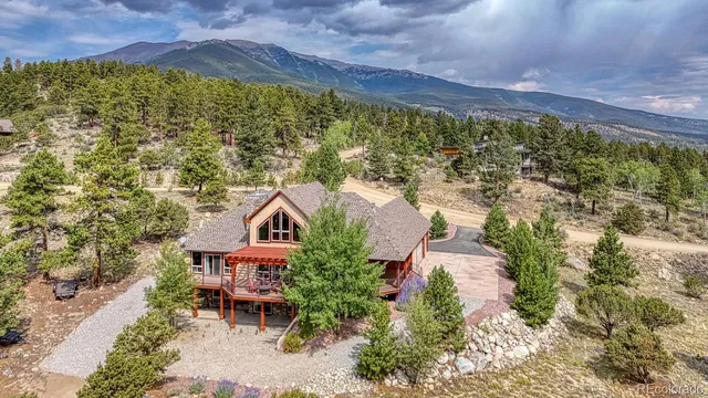 an aerial view of residential houses with outdoor space and trees