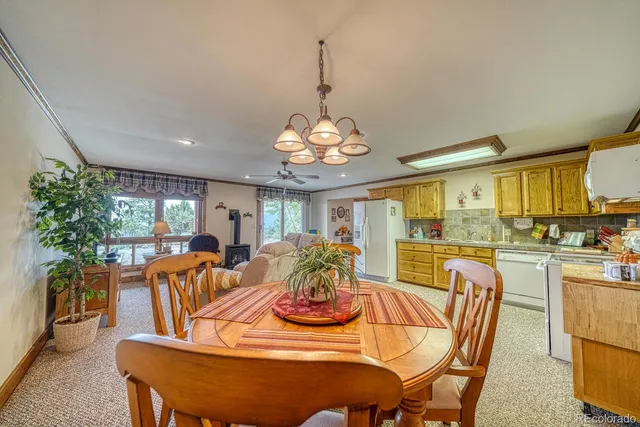 a kitchen with granite countertop cabinets stainless steel appliances a sink and a window