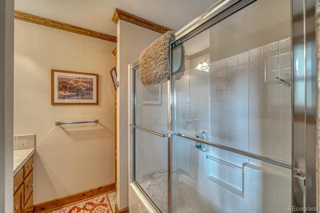 a view of a livingroom with wooden floor and a bookshelf