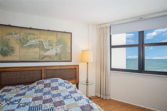 a view of a bedroom with wooden floor and a bed