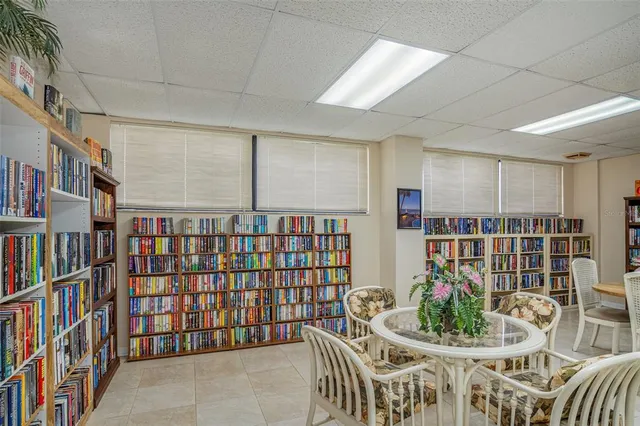 a living room with lots of furniture and a book shelf