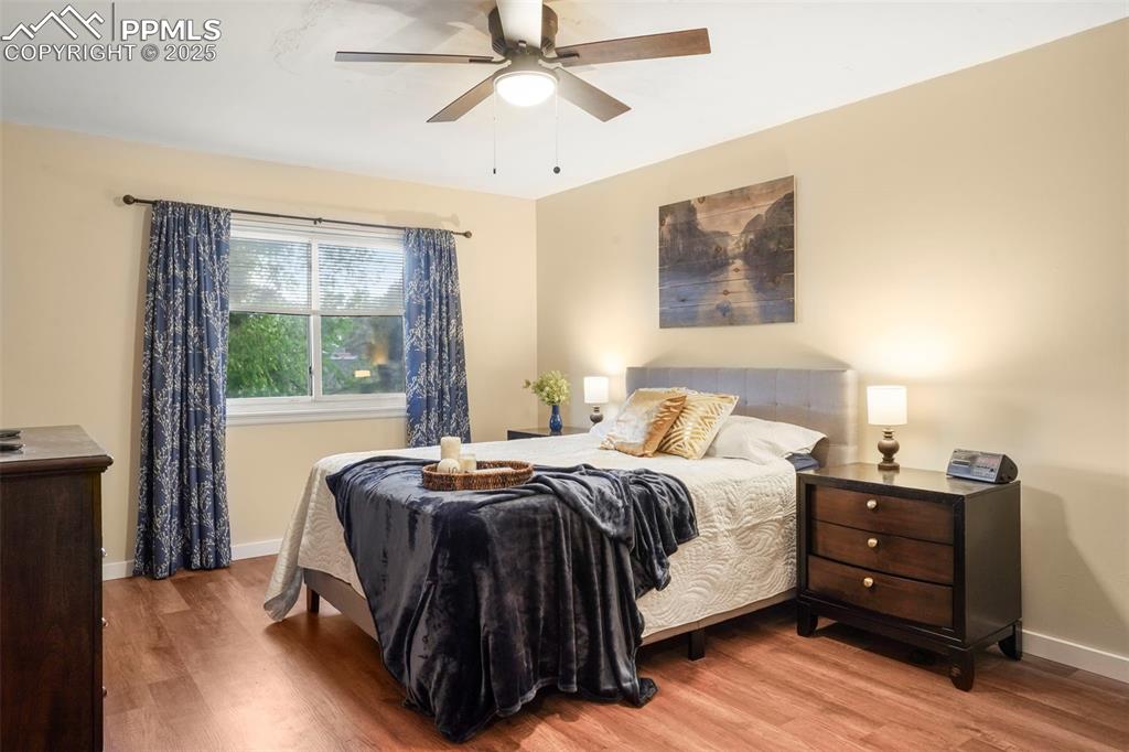 2417 Ranch Lane Colorado Springs, CO 80918 - Photo 12 of 32 a bedroom with a bed window and a mirror