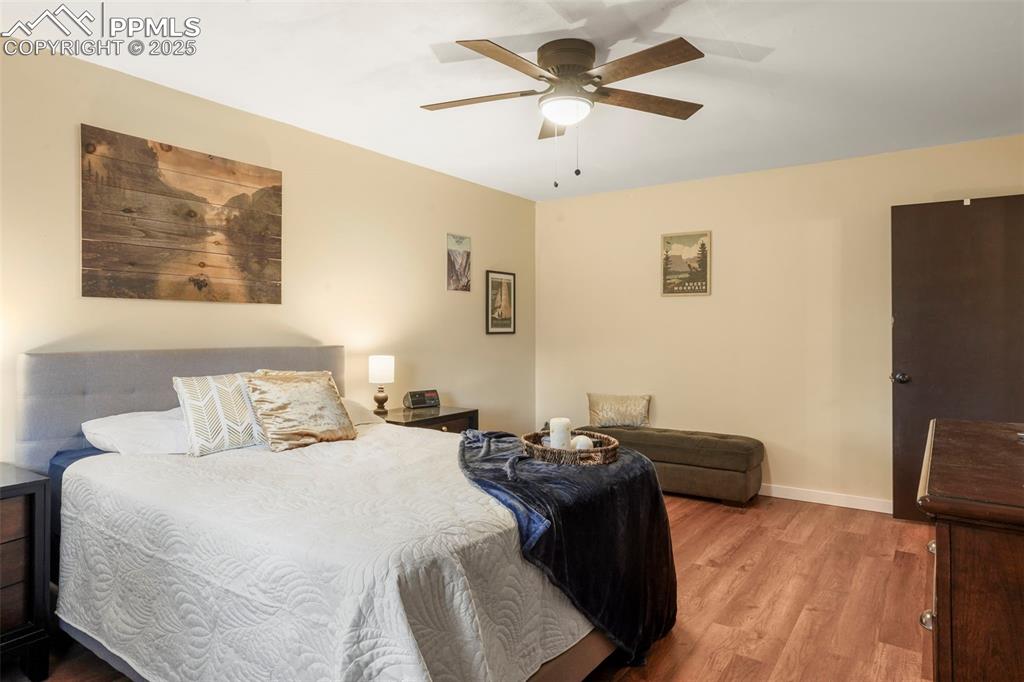 2417 Ranch Lane Colorado Springs, CO 80918 - Photo 13 of 32 a bedroom with a bed and a flat screen tv