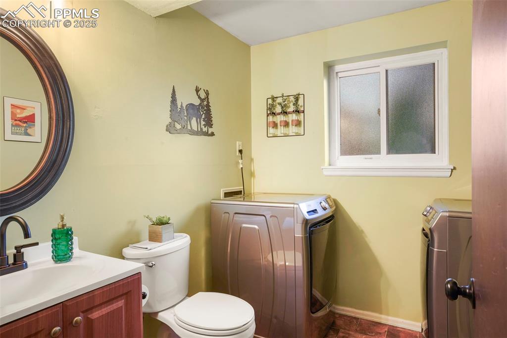 2417 Ranch Lane Colorado Springs, CO 80918 - Photo 18 of 32 a bathroom with a toilet sink and mirror
