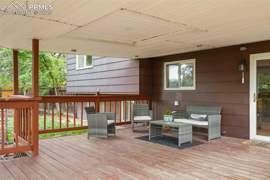 2417 Ranch Lane Colorado Springs, CO 80918 - Photo 22 of 32 a view of a house with wooden deck and furniture