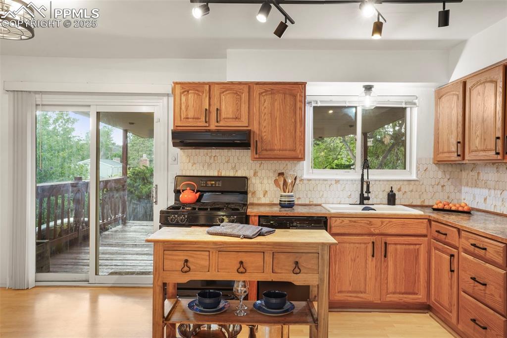2417 Ranch Lane Colorado Springs, CO 80918 - Photo 6 of 32 a kitchen with a stove a sink and a microwave