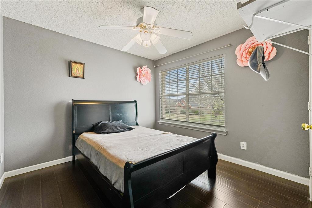 1818 Cedar Ridge Drive Mesquite, TX 75181 - Photo 15 of 21 Bedroom with dark wood-style flooring, a textured ceiling, and a ceiling fan