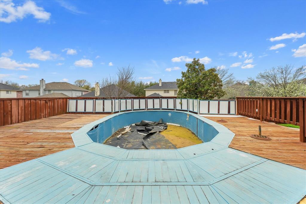 1818 Cedar Ridge Drive Mesquite, TX 75181 - Photo 19 of 21 View of swimming pool featuring a wooden deck and a residential view