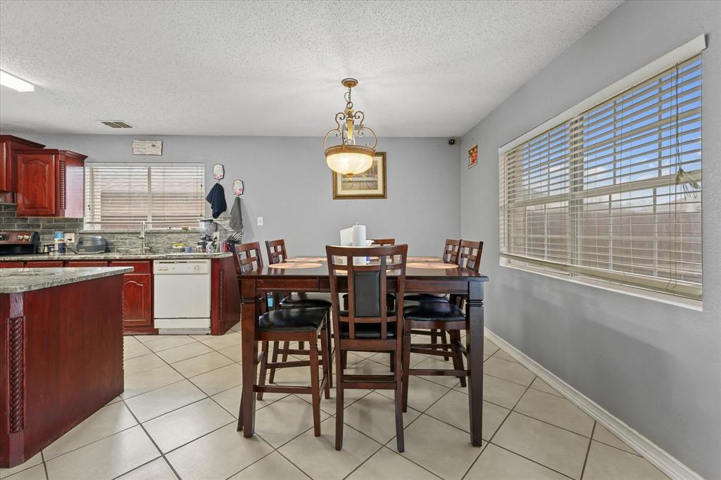 1818 Cedar Ridge Drive Mesquite, TX 75181 - Photo 9 of 21 Dining room featuring light tile patterned floors and a textured ceiling