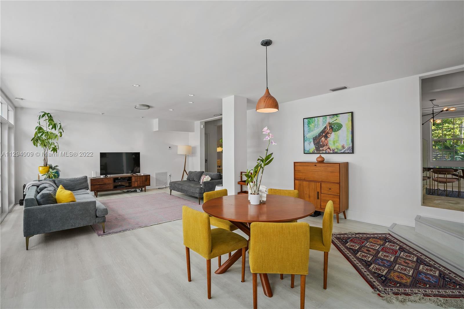 1701 Micanopy Avenue Miami, FL 33133 - Photo 14 of 46 a living room with furniture and a flat screen tv