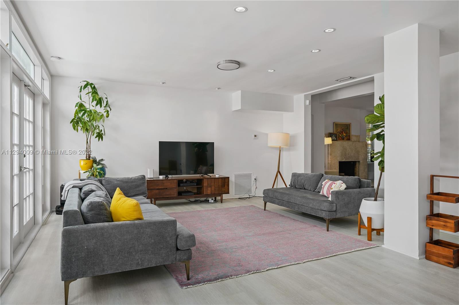 1701 Micanopy Avenue Miami, FL 33133 - Photo 15 of 46 a living room with furniture and a flat screen tv