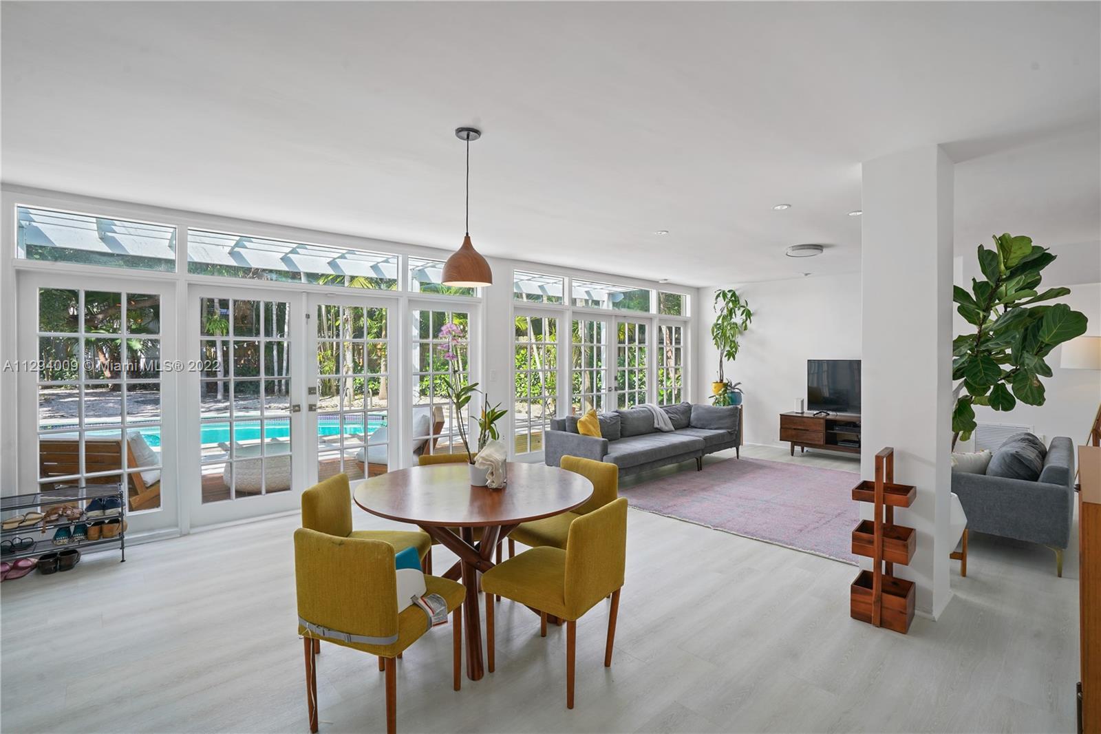 1701 Micanopy Avenue Miami, FL 33133 - Photo 16 of 46 a living room with furniture and potted plants