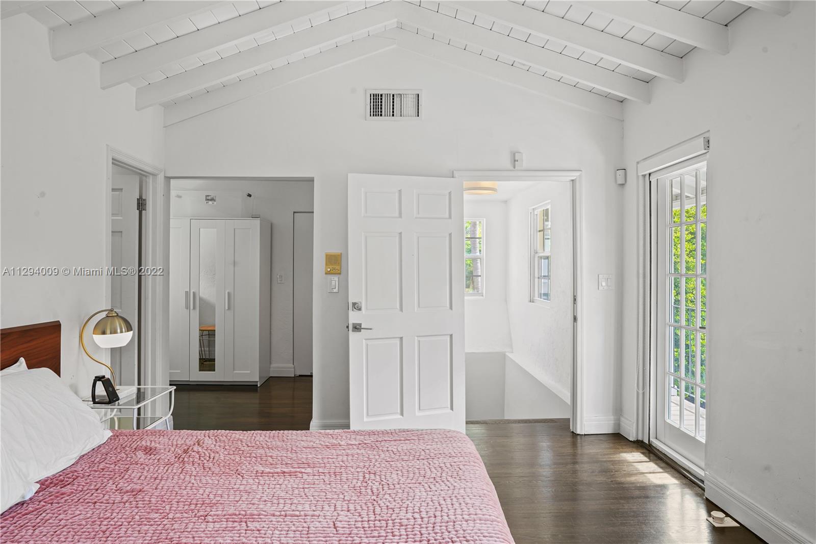 1701 Micanopy Avenue Miami, FL 33133 - Photo 22 of 46 a bedroom with a bed and a table