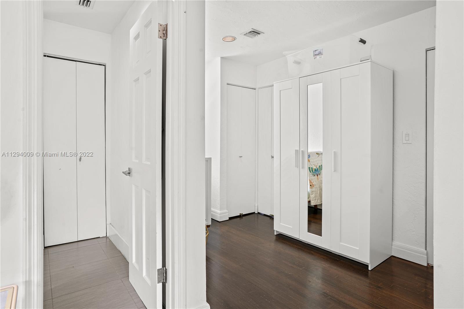 1701 Micanopy Avenue Miami, FL 33133 - Photo 23 of 46 a view of a hallway with wooden floor