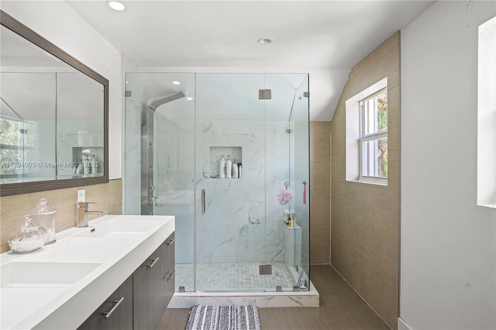 1701 Micanopy Avenue Miami, FL 33133 - Photo 24 of 46 a bathroom with a double vanity sink mirror and shower