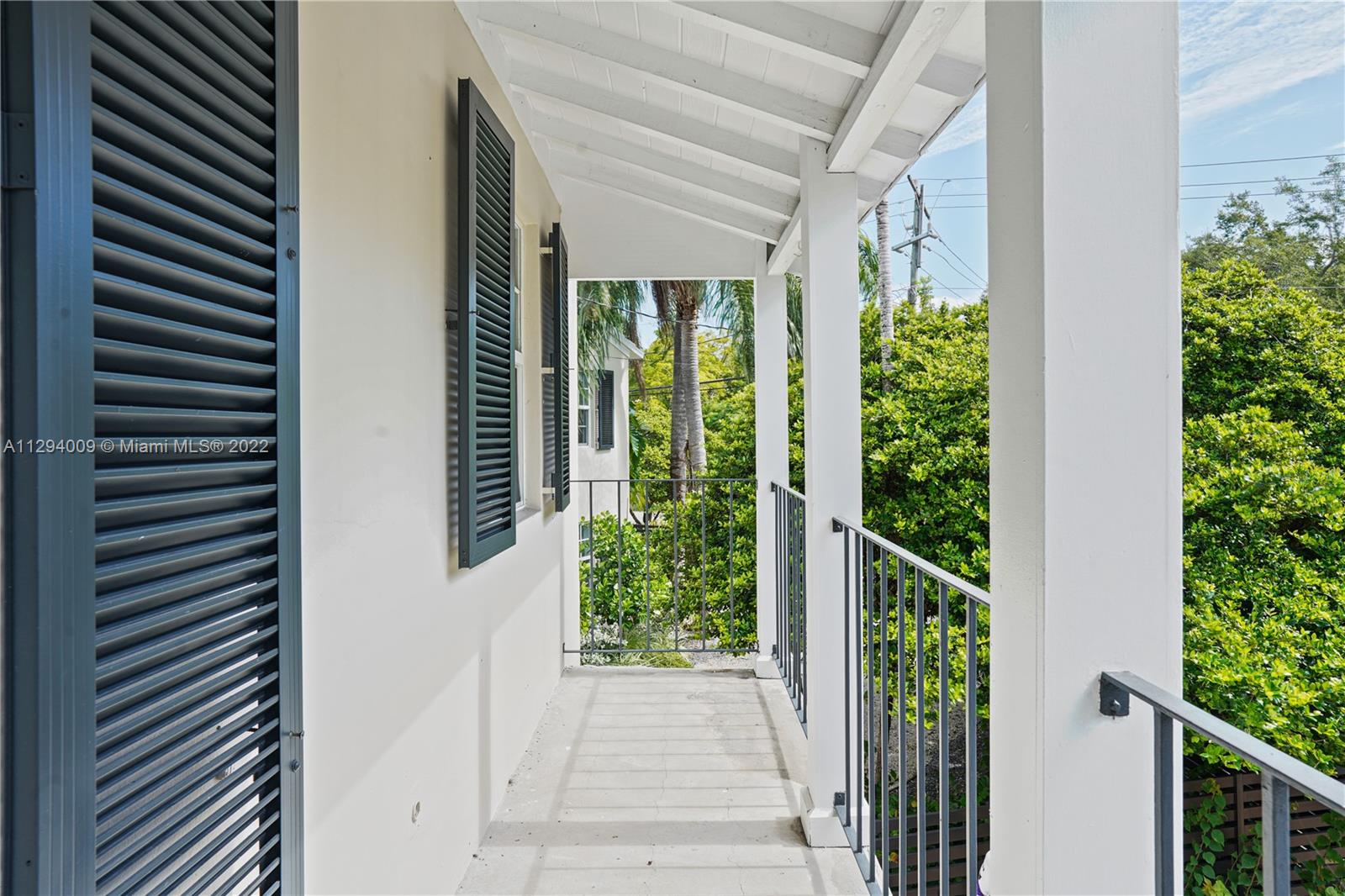 1701 Micanopy Avenue Miami, FL 33133 - Photo 25 of 46 a view of a entrance to house and trees