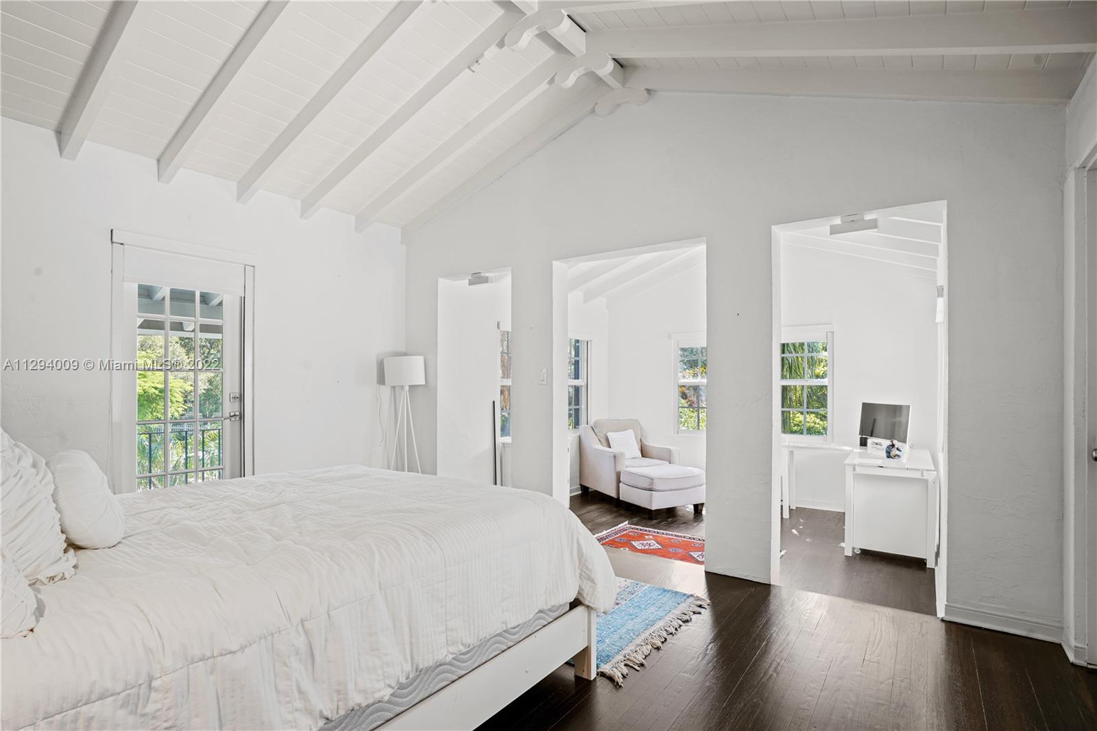 1701 Micanopy Avenue Miami, FL 33133 - Photo 30 of 46 a bedroom with a bed couch and a window