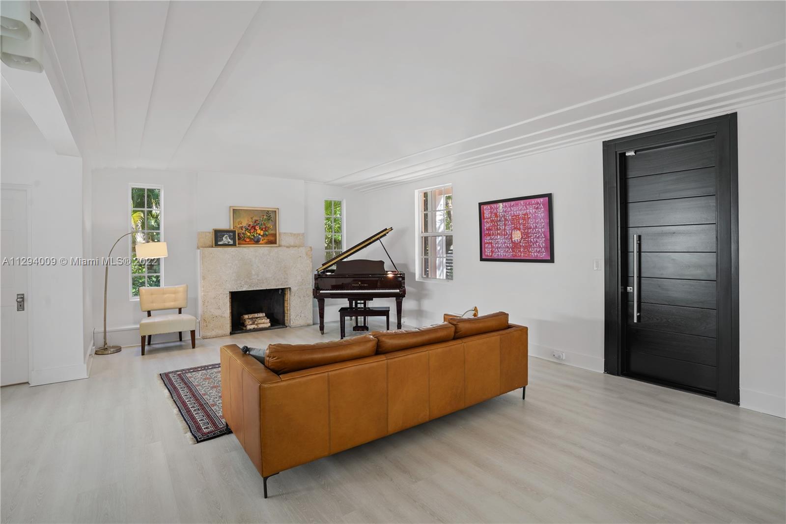 1701 Micanopy Avenue Miami, FL 33133 - Photo 3 of 46 a living room with furniture and a fireplace