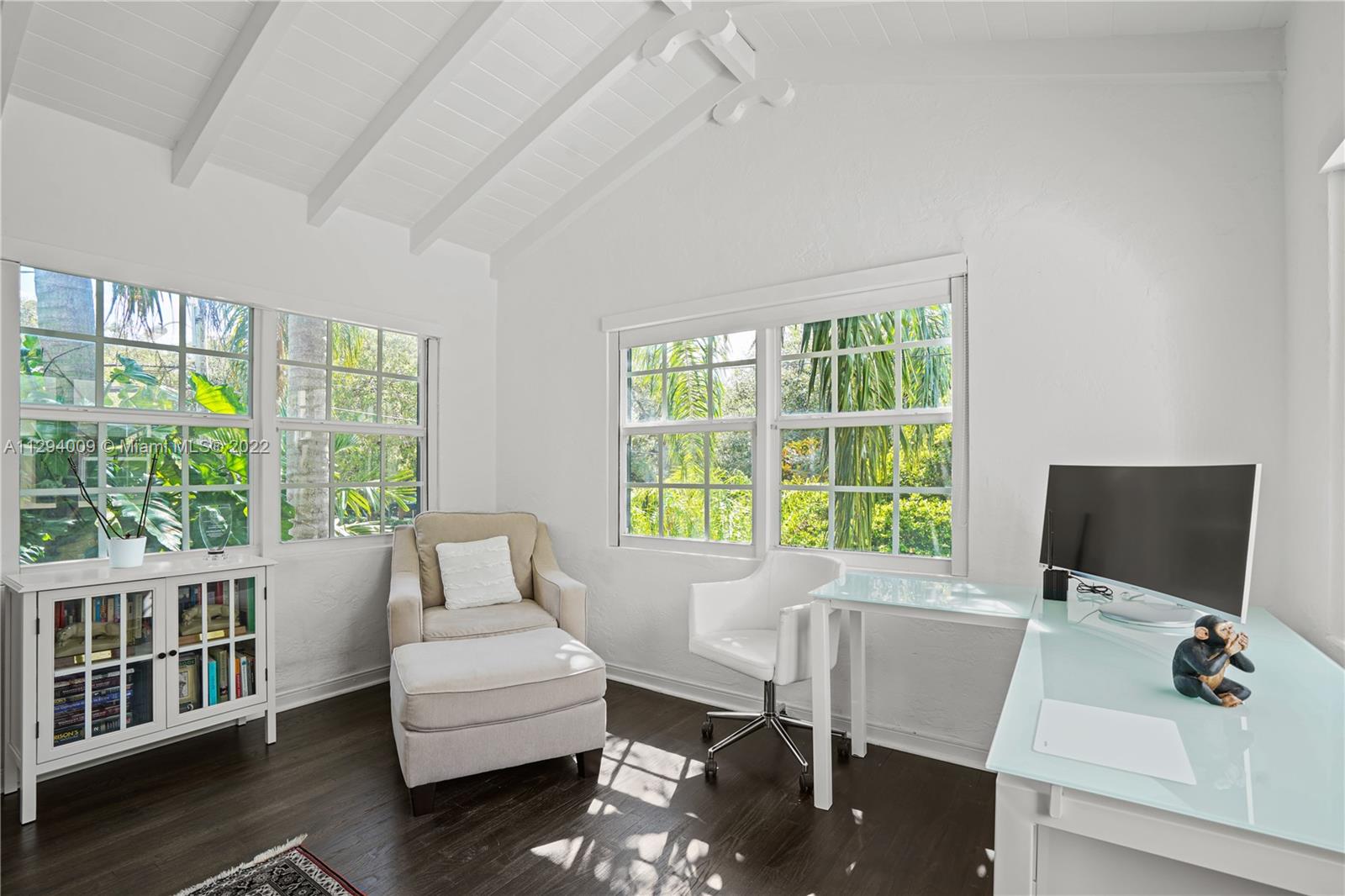 1701 Micanopy Avenue Miami, FL 33133 - Photo 33 of 46 a living room with furniture a flat screen tv and a window